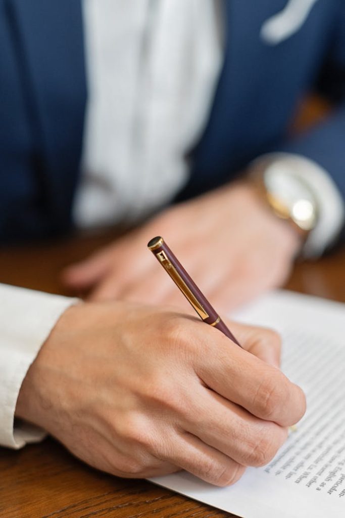a-person-signing-a-document-in-close-up-shot-8730987 Impressum